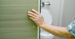Image of Person Opening Bathroom Door To Toilet
