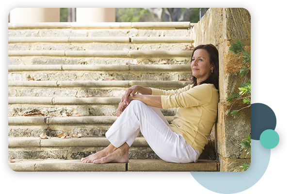 happy woman sitting on stone steps