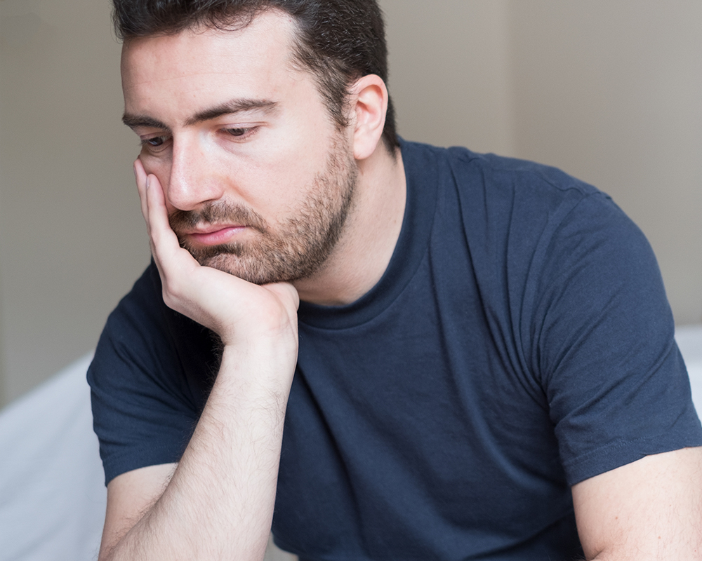 sad man in bed