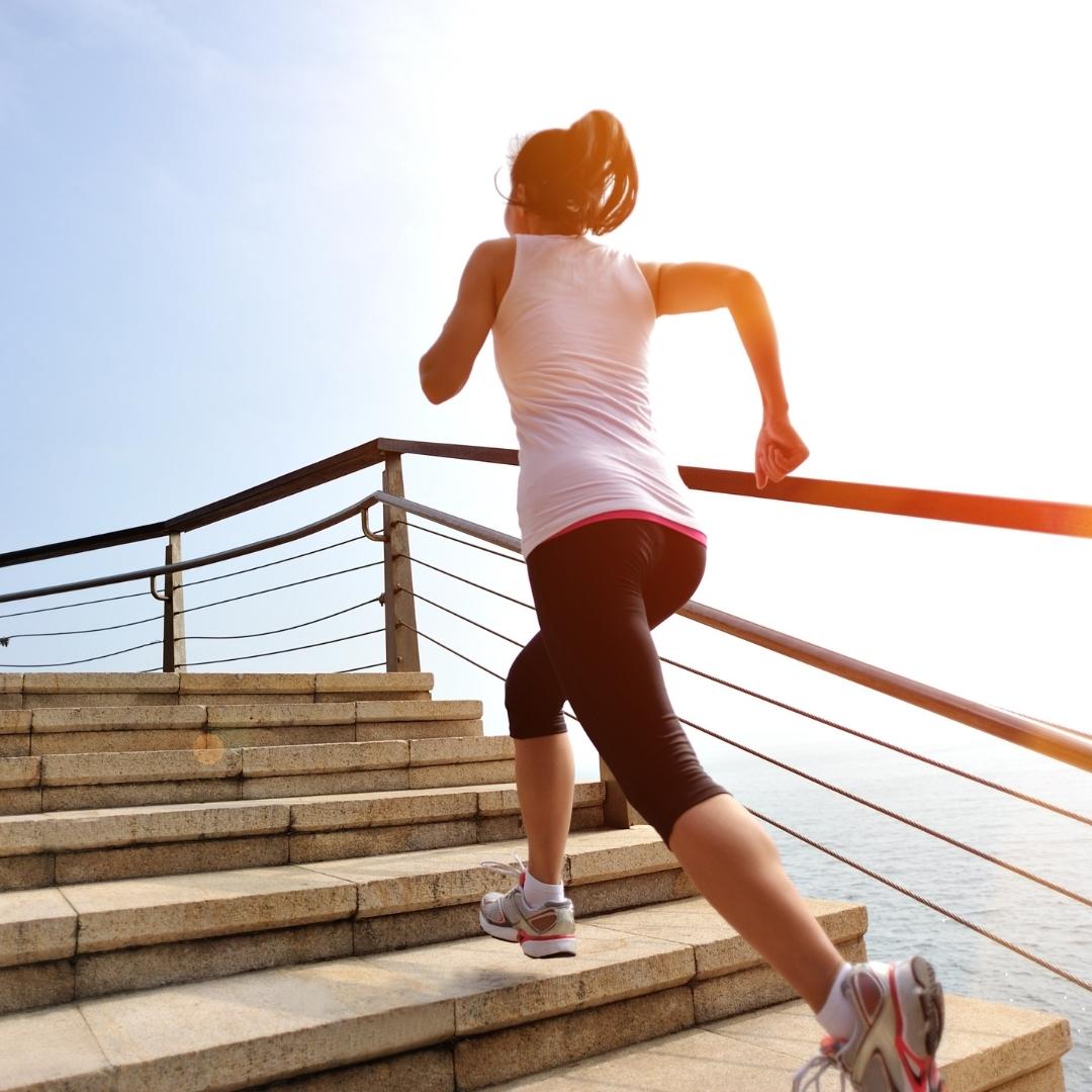 woman exercising running up stairs