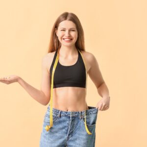 woman showing her pants are too large