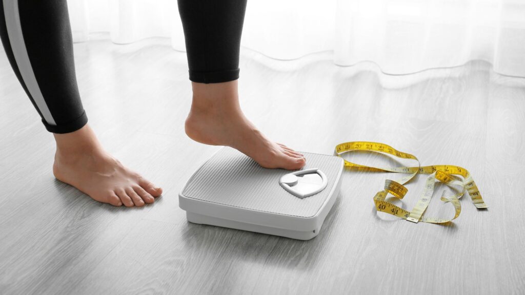 woman stepping on scale