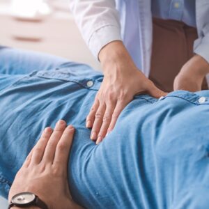 Doctor doing an exam on a patient's stomach. 