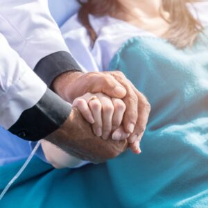 Doctor holding a patient's hand. 
