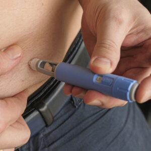 Person injecting a weight loss injection. 