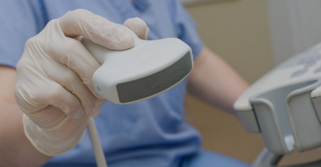 hand holding ultrasound tool