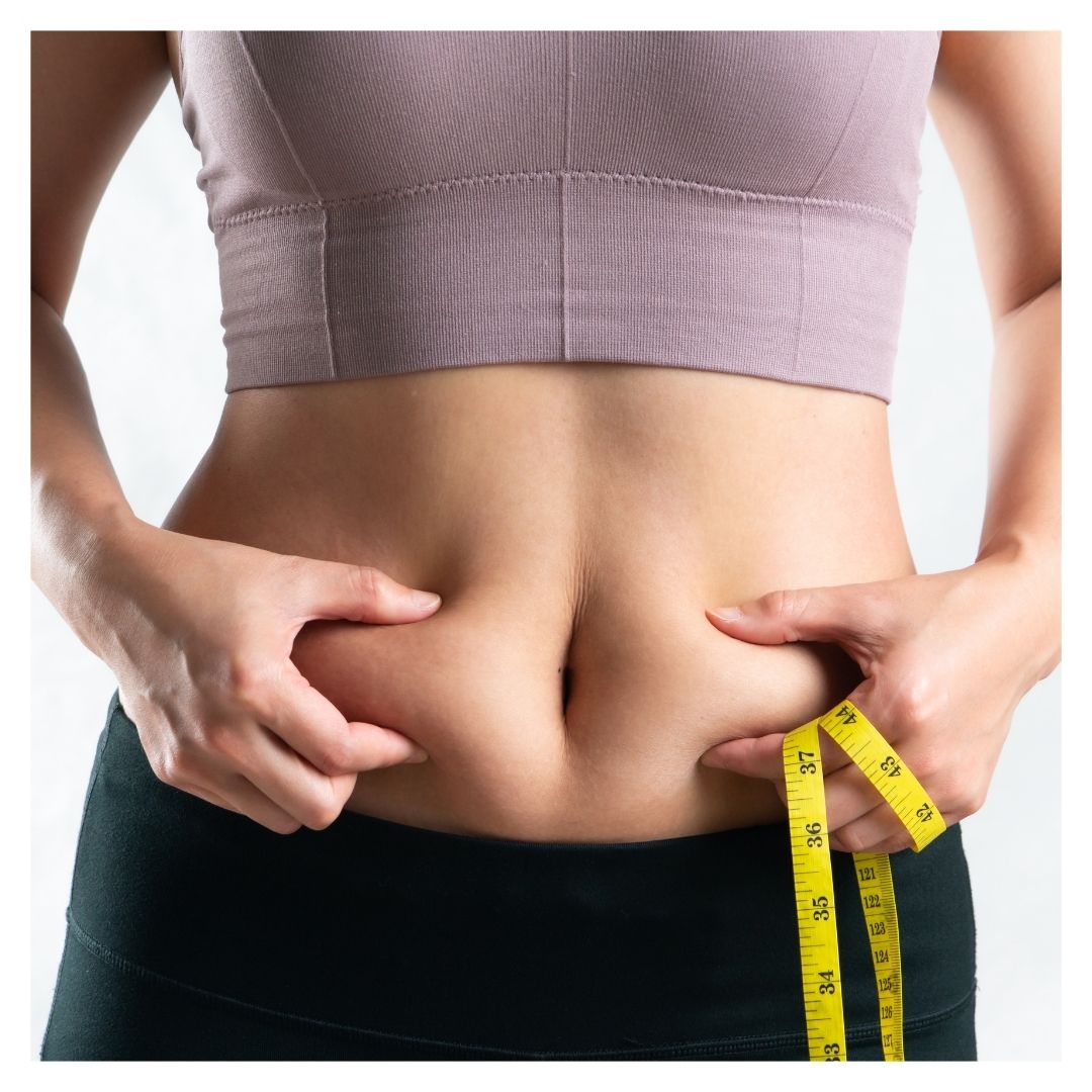 Healthy woman holding tape measure and pinching body fat