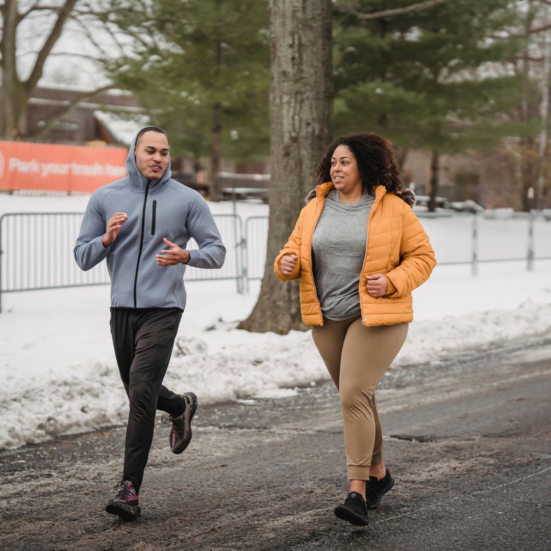 man and woman running outside