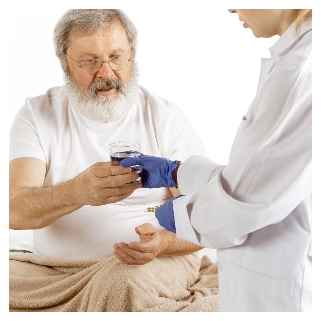 nurse handing water to patient