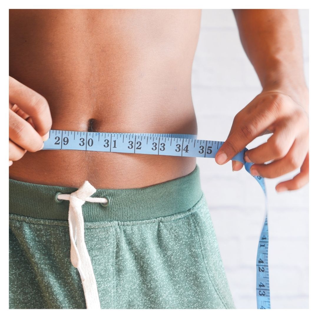 man measuring his waist