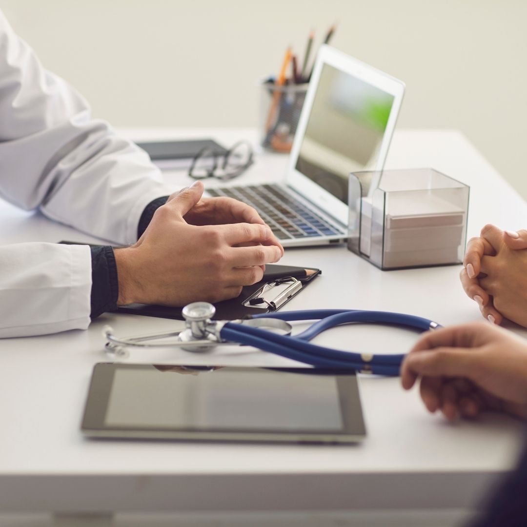 couple talking to a gastroenterologist about test results