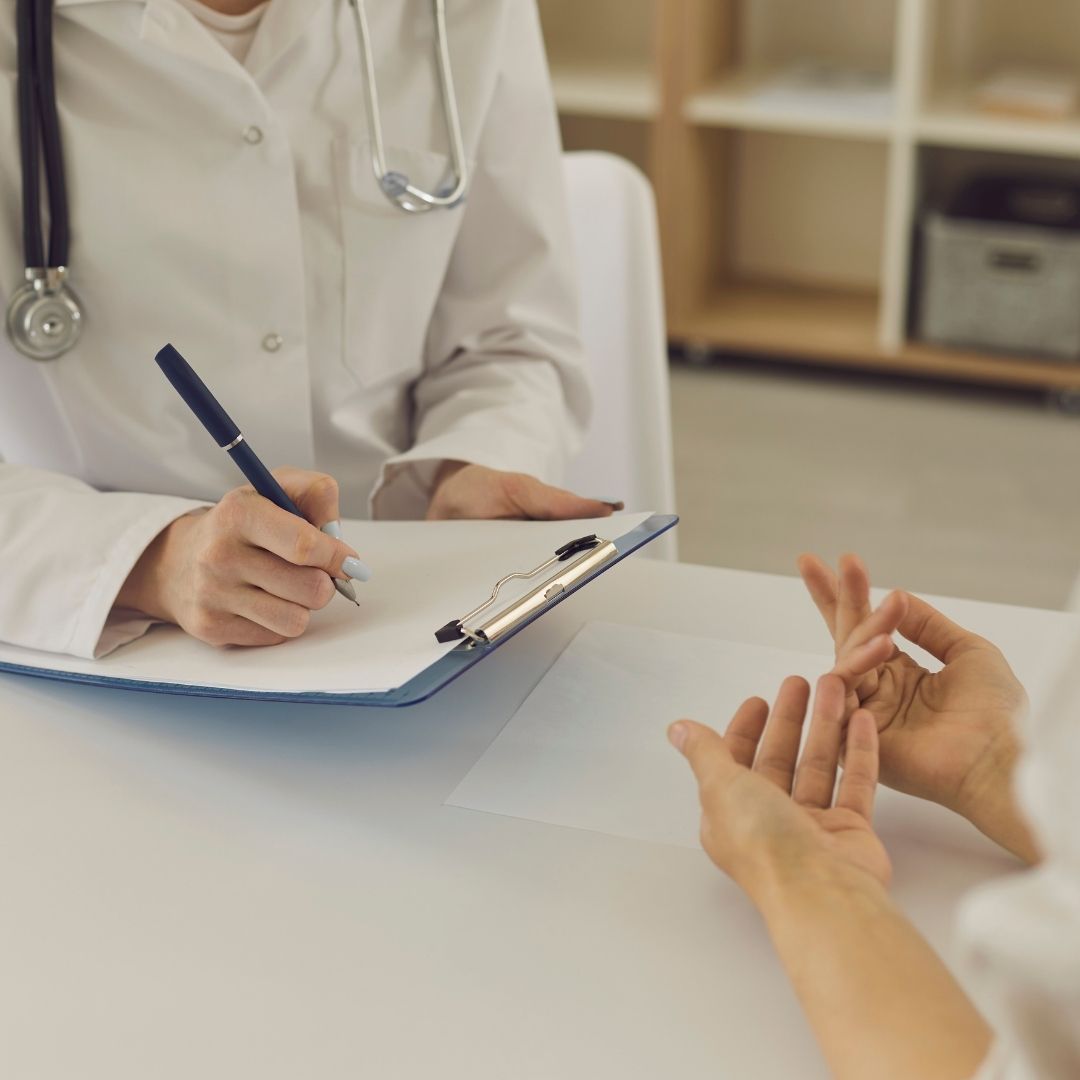 woman discussing symptoms with a doctor