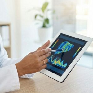 A doctor points with a pen to digital liver health charts on a handheld tablet.